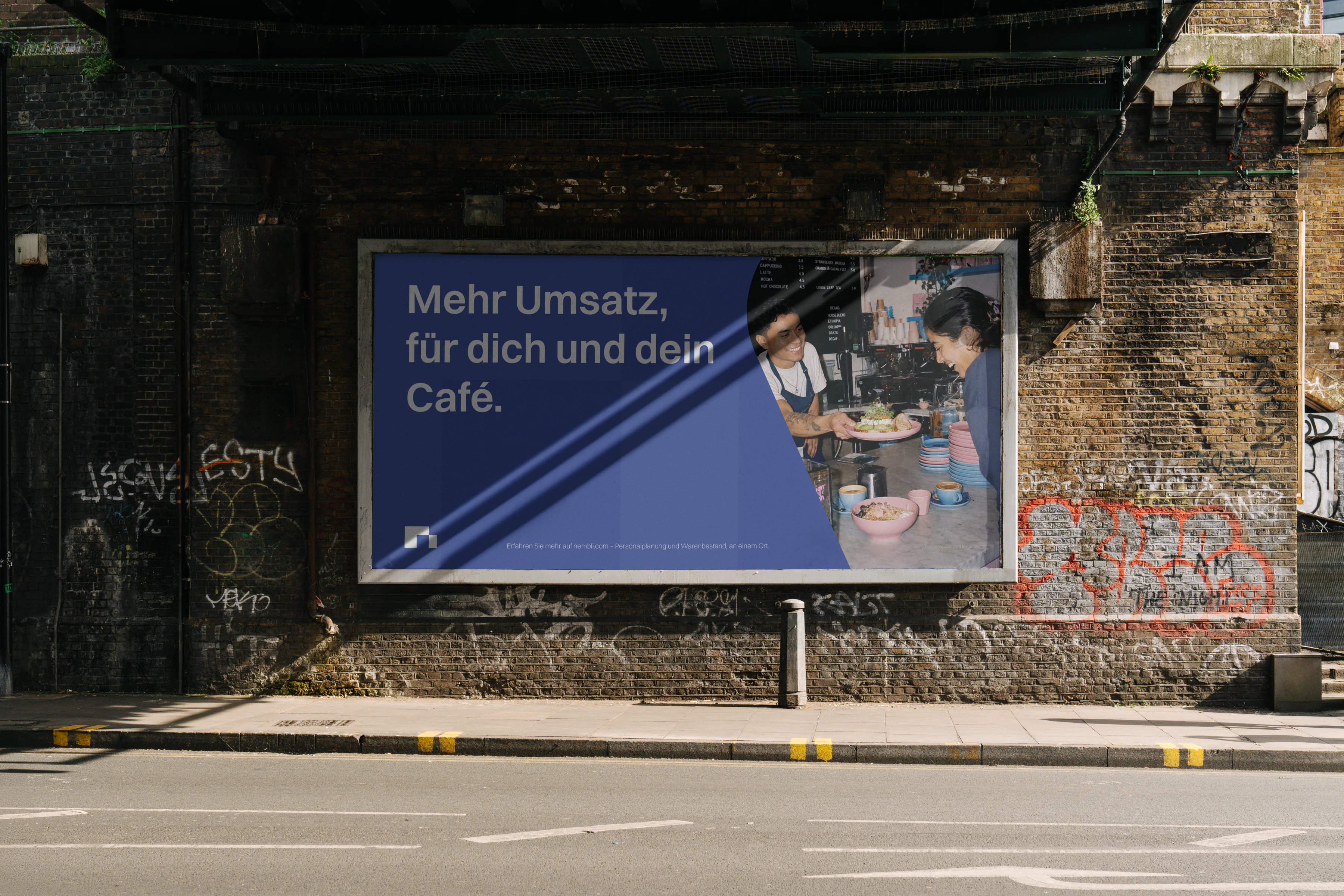 Nembli billboard installed beneath a railway bridge.