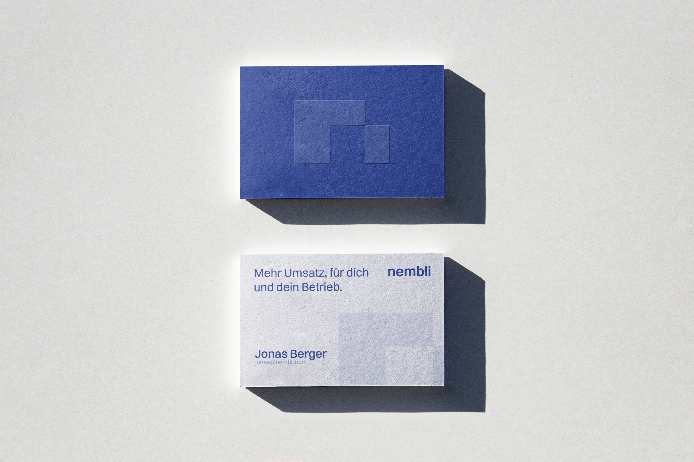 Blue and white nembli business cards.
